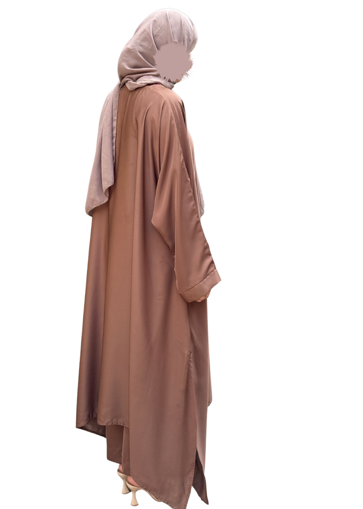 Person wearing a long, light brown dress with a matching hijab on a white background