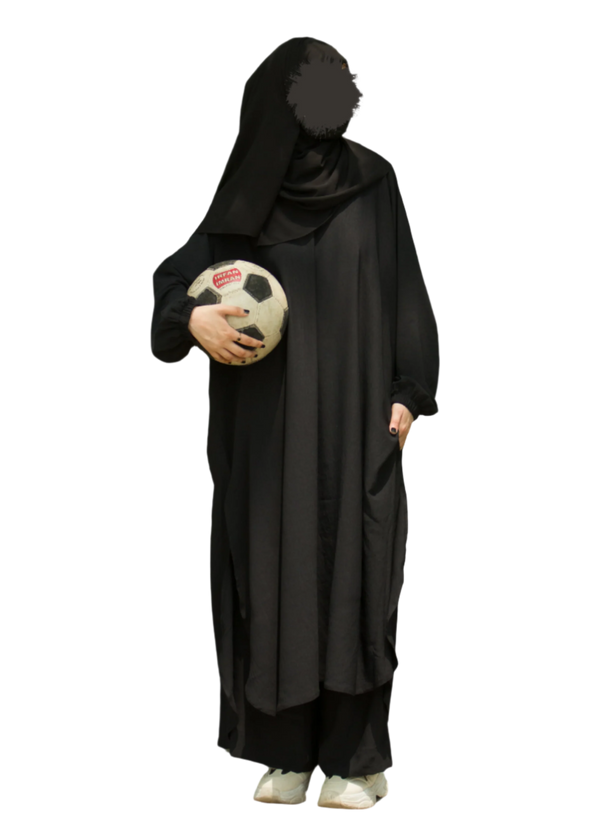 Person wearing a black abaya holding a soccer ball on a white background